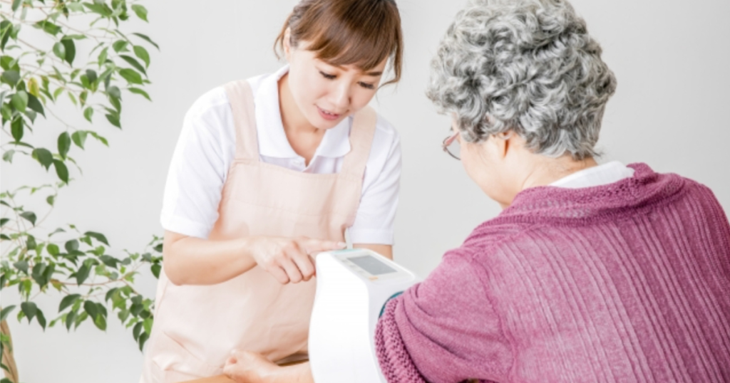 血圧を測る介護者